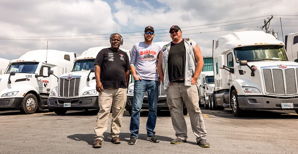 Truckers in Front of Trucks