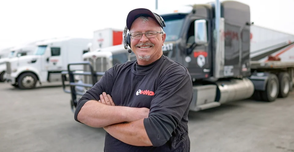 Truck Driver Wearing a Headset Smiles